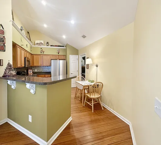 a dining room with furniture and wooden floor