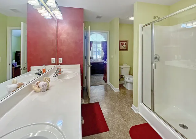a en suite bathroom with a tub shower and a sink