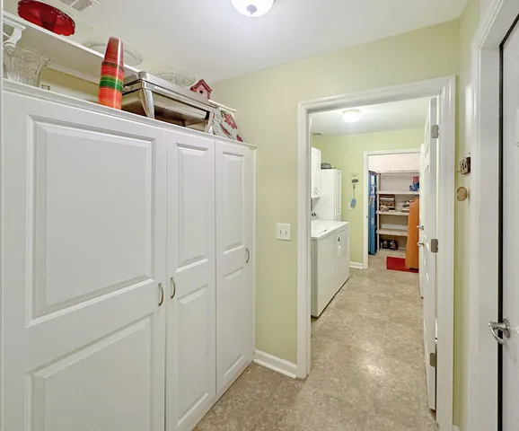 a view of a hallway to closet and cabinet