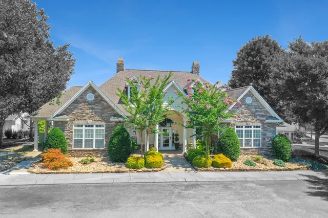 a view of house with outdoor space and sitting area