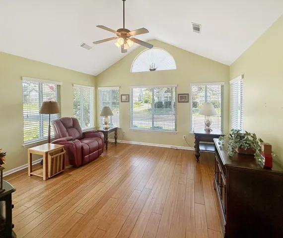 a living room with furniture and wooden floor