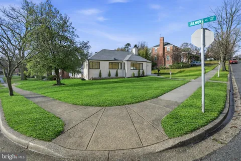 a view of a big house with a big yard and potted plants