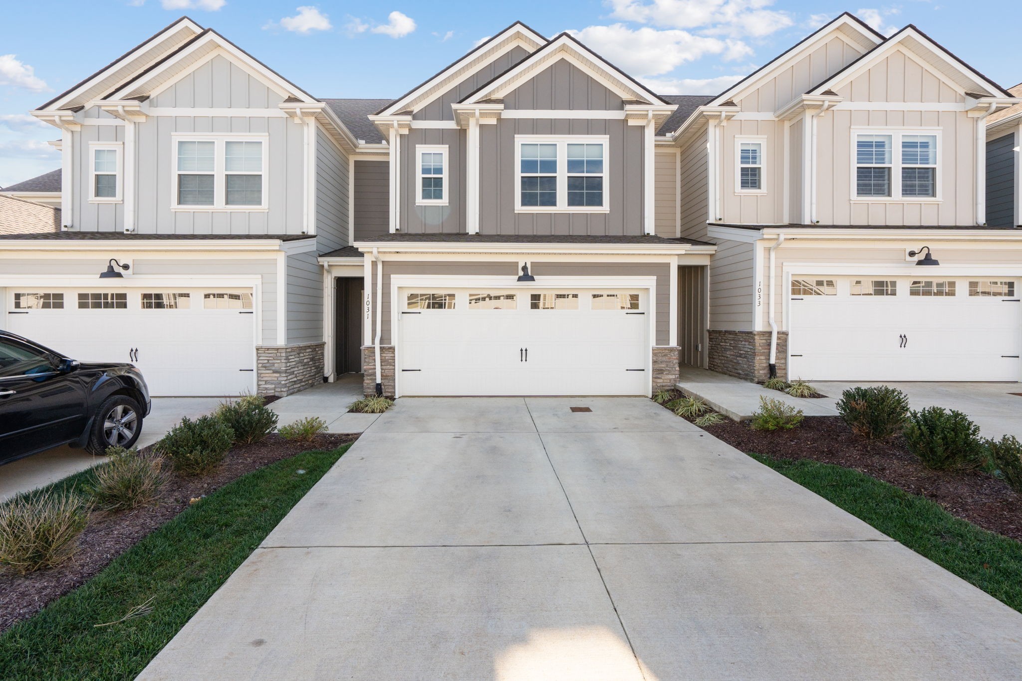 1031 June Wilde Ridge Spring Hill, TN 37174 - Photo 1 of 32 a view of a white house with a yard and garage