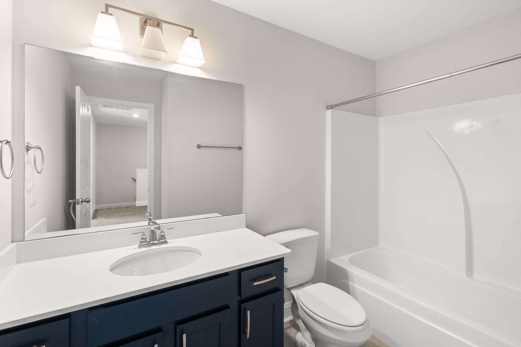 1031 June Wilde Ridge Spring Hill, TN 37174 - Photo 11 of 32 a bathroom with a sink a toilet a mirror and shower
