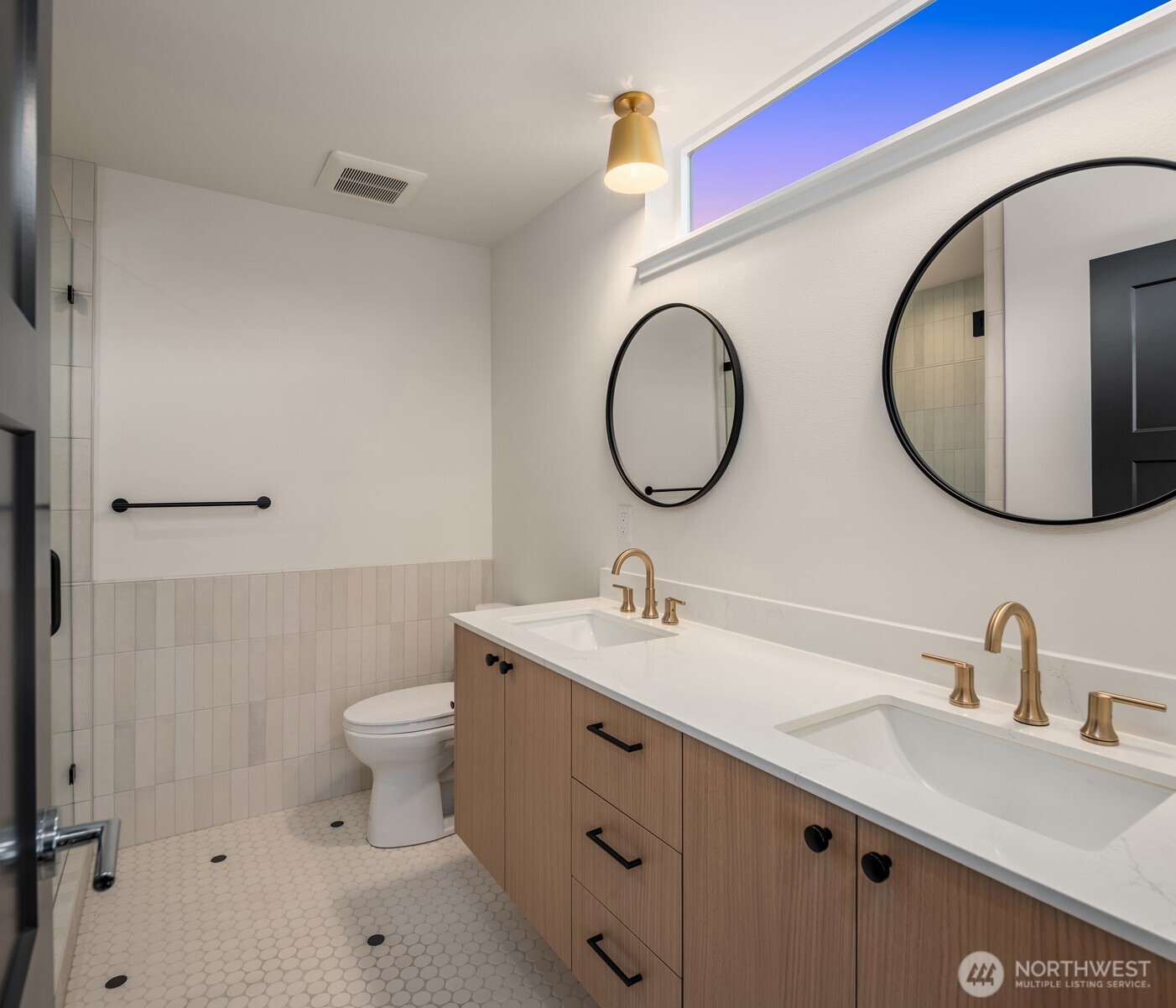 3612 Francis Avenue North Seattle, WA 98103 - Photo 12 of 36 a bathroom with a toilet sink and mirror