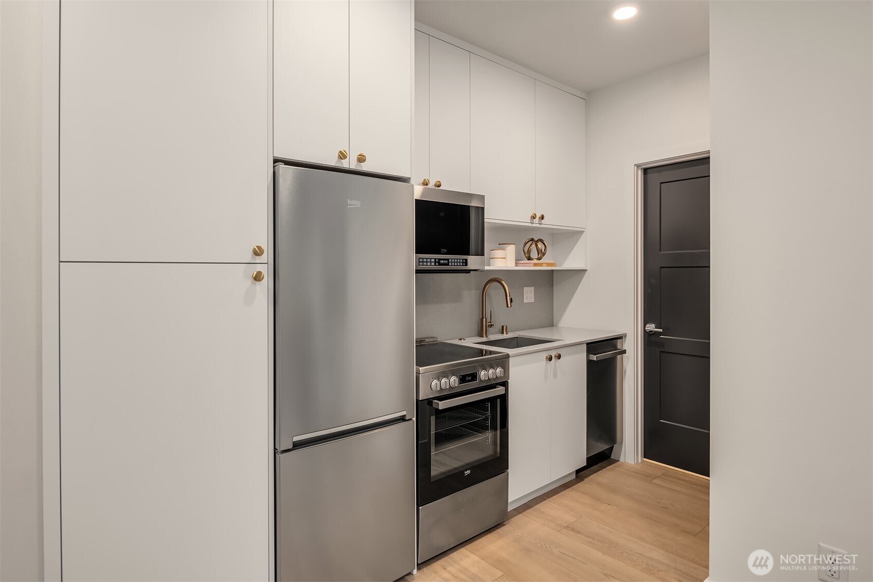 3612 Francis Avenue North Seattle, WA 98103 - Photo 21 of 36 a kitchen with a refrigerator stove and microwave