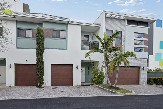 an aerial view of a residential apartment building with a yard