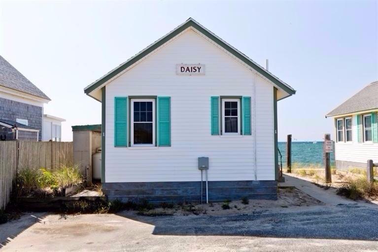 276 Shore Road, Unit 1 Truro, MA 02666 - Photo 1 of 12 a front view of a house with a yard