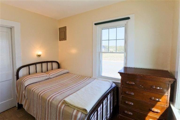 276 Shore Road, Unit 1 Truro, MA 02666 - Photo 10 of 12 a bedroom with a bed and a window