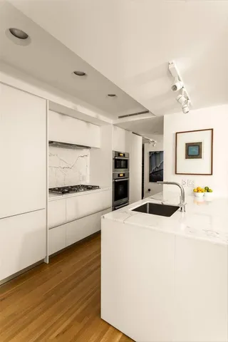 a kitchen with a sink and a stove top oven