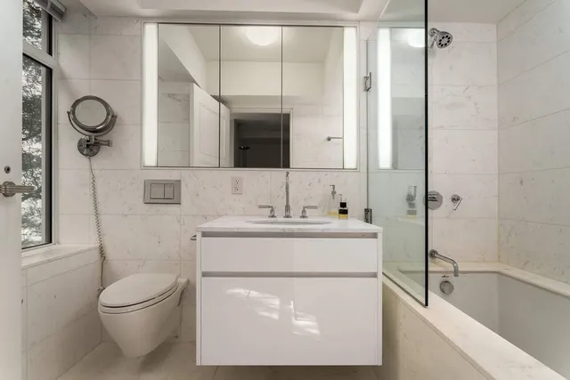 a bedroom with a bed a table and chair