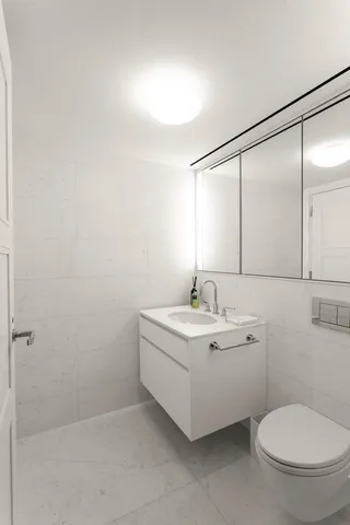 a bathroom with a toilet sink and shower
