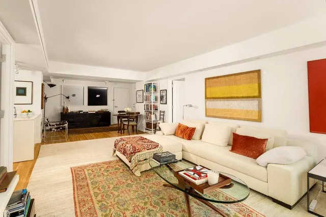 a living room with furniture large window and a flat screen tv