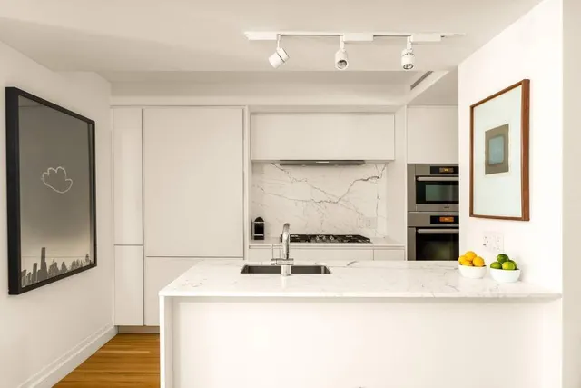 a living room with furniture wooden floor and a large window