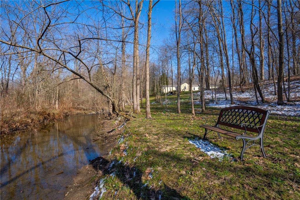 264 Baird Road Edinburg, PA 16116 - Photo 20 of 23 a view of a bench in a backyard