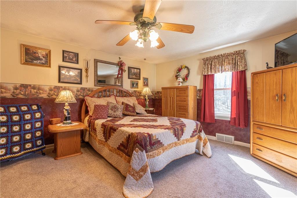 264 Baird Road Edinburg, PA 16116 - Photo 9 of 23 a bed room with a bed and a chandelier