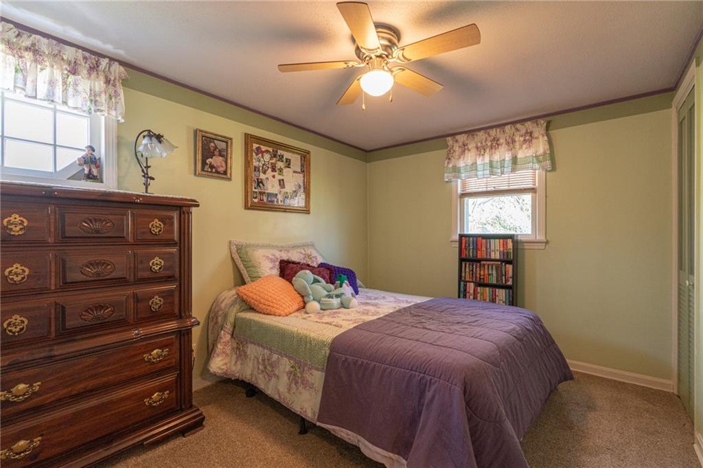 264 Baird Road Edinburg, PA 16116 - Photo 10 of 23 a bedroom with a bed a dresser and next to a window