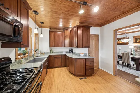 a kitchen with stainless steel appliances granite countertop a stove and a sink