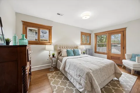 a bedroom with a bed and a large window