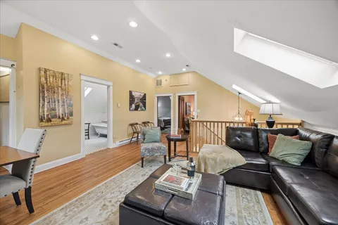a living room with furniture and wooden floor