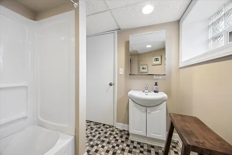 a bathroom with a sink a mirror and a bathtub
