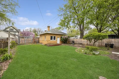 a view of house with backyard