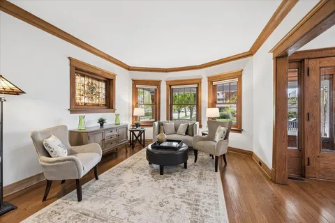 a living room with furniture and floor to ceiling windows
