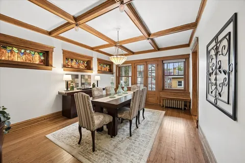 a dining room with furniture and wooden floor