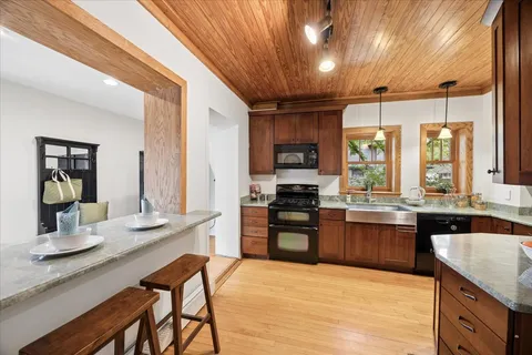 a kitchen with stainless steel appliances kitchen island granite countertop a sink and cabinets