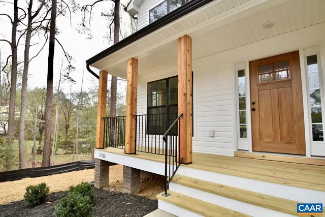 a view of a porch with a floor to ceiling window and wooden floor