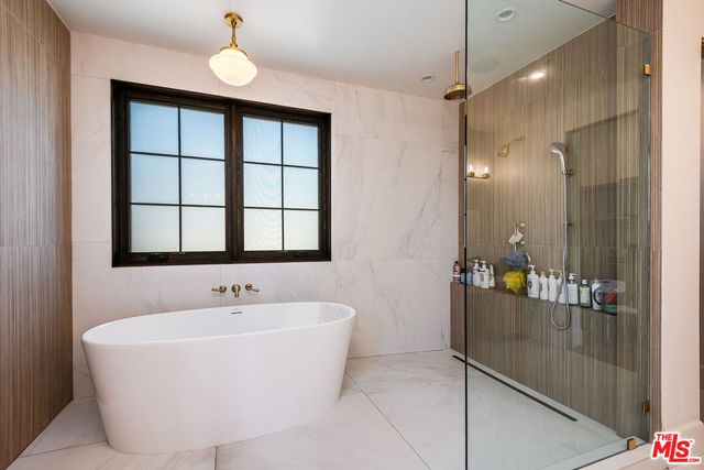 a bathroom with a bathtub and shower