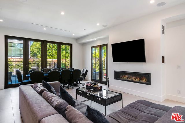 a living room with furniture fireplace and a flat screen tv