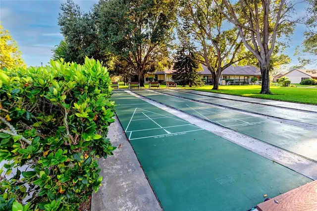 a patio with a table and chairs under an umbrella