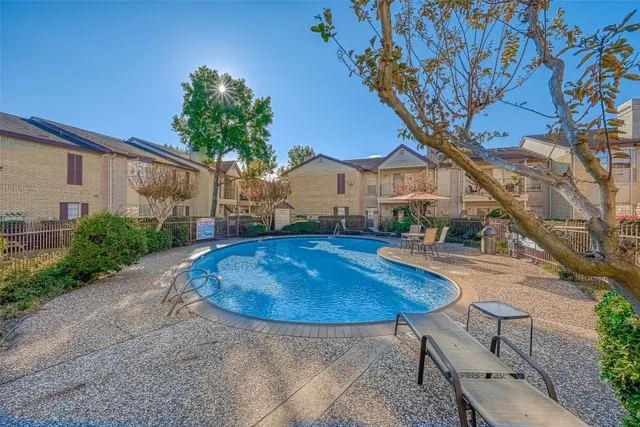 a view of a house with swimming pool and sitting area