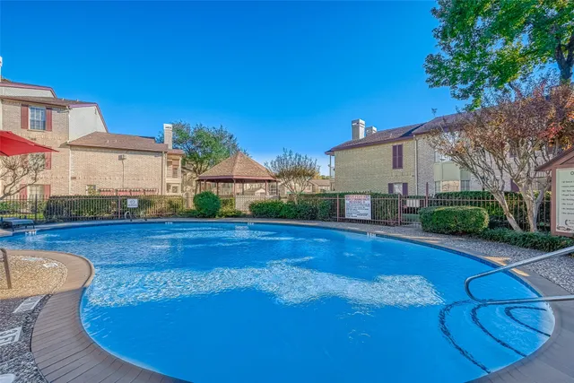a view of a garden with a building in the background