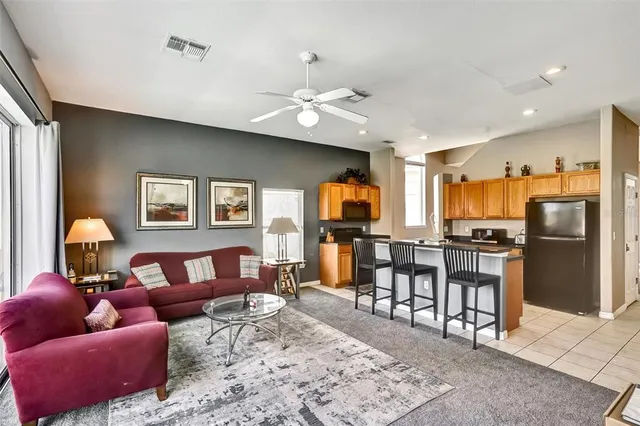 a living room with furniture fireplace and a window