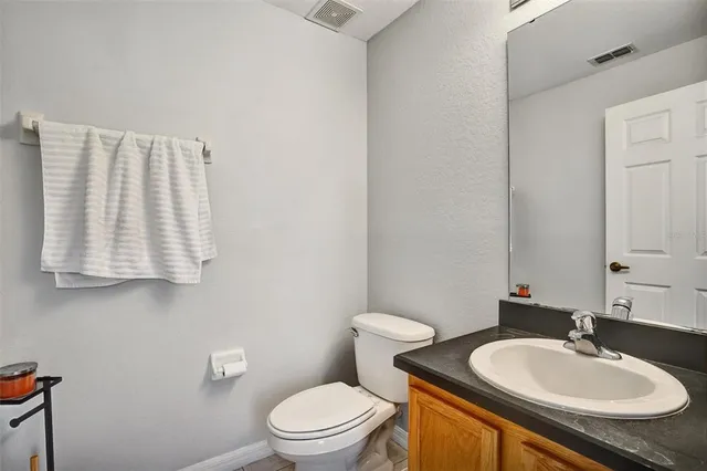 a bathroom with a sink toilet and mirror