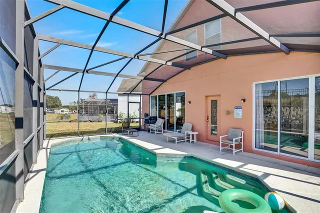 a view of a backyard with swimming pool