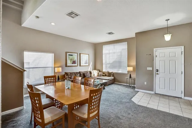 a dining room with furniture and window