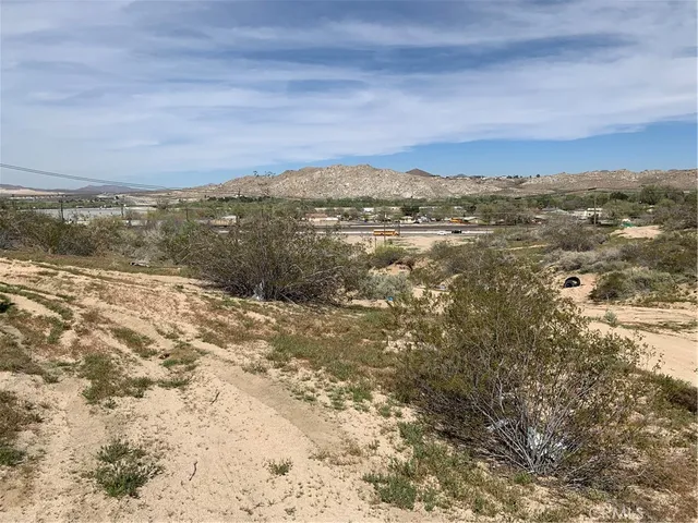 a view of a large building with mountains in the background