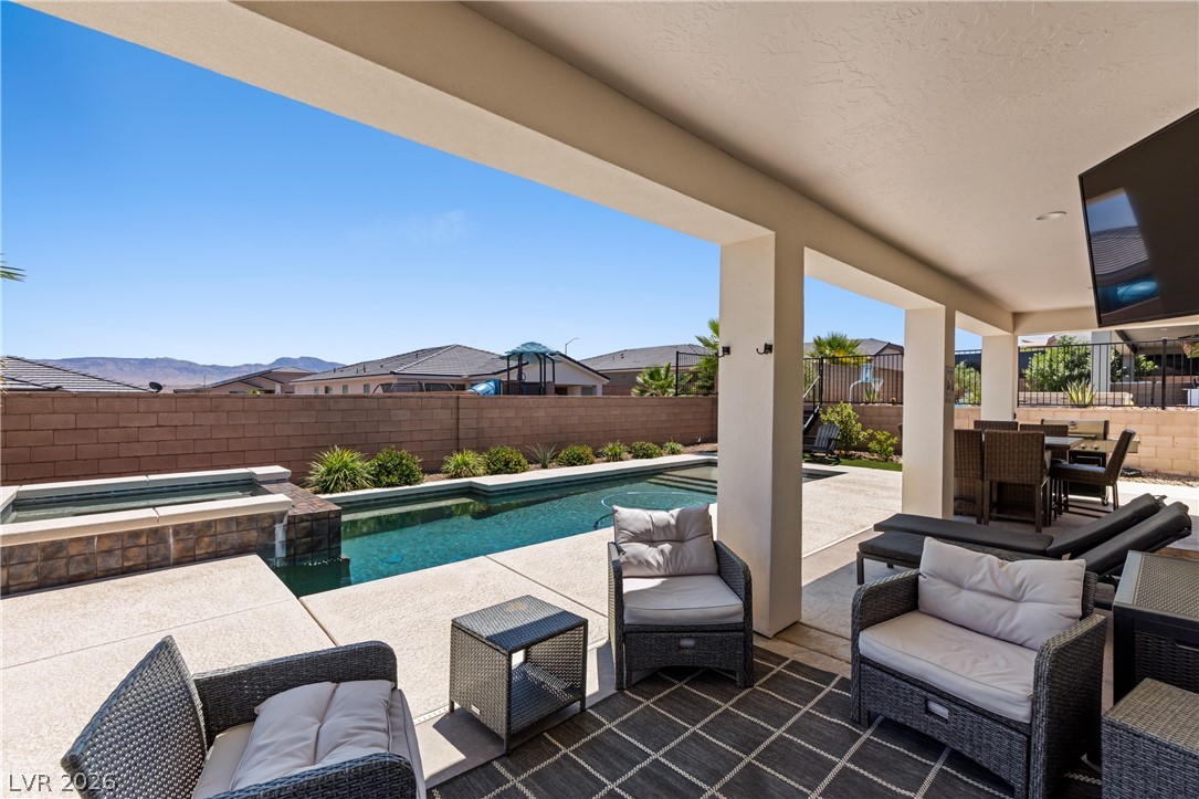 1436 Manassas Ridge Mesquite, NV 89027 - Photo 47 of 77 An inviting covered patio and sparkling pool offer ideal outdoor entertaining with mountain vistas.