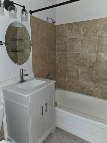 a bathroom with a sink and mirror