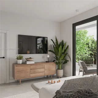 a living room with furniture potted plant and a large window