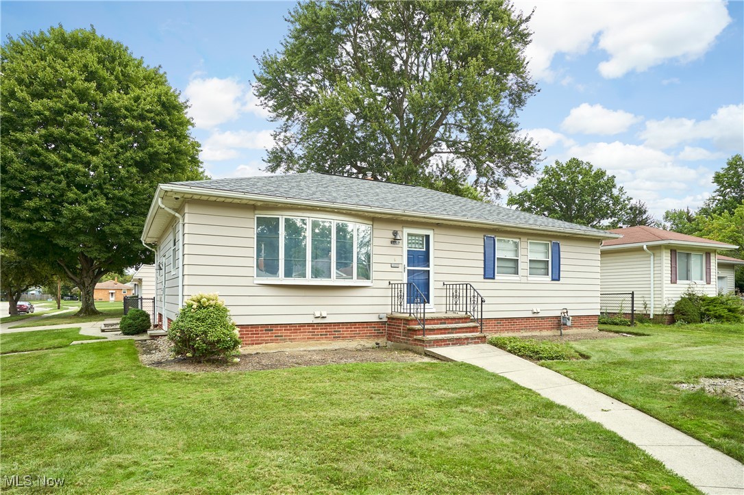 1129 Homestead Road Cleveland, OH 44121 - Photo 2 of 26 View of front of house with a front lawn and a shingled roof
