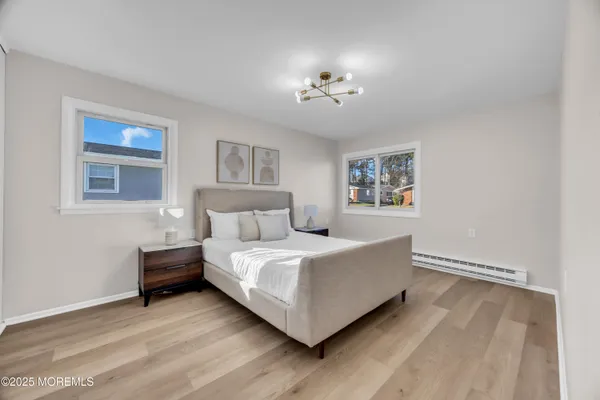 a bedroom with a bed and a chandelier