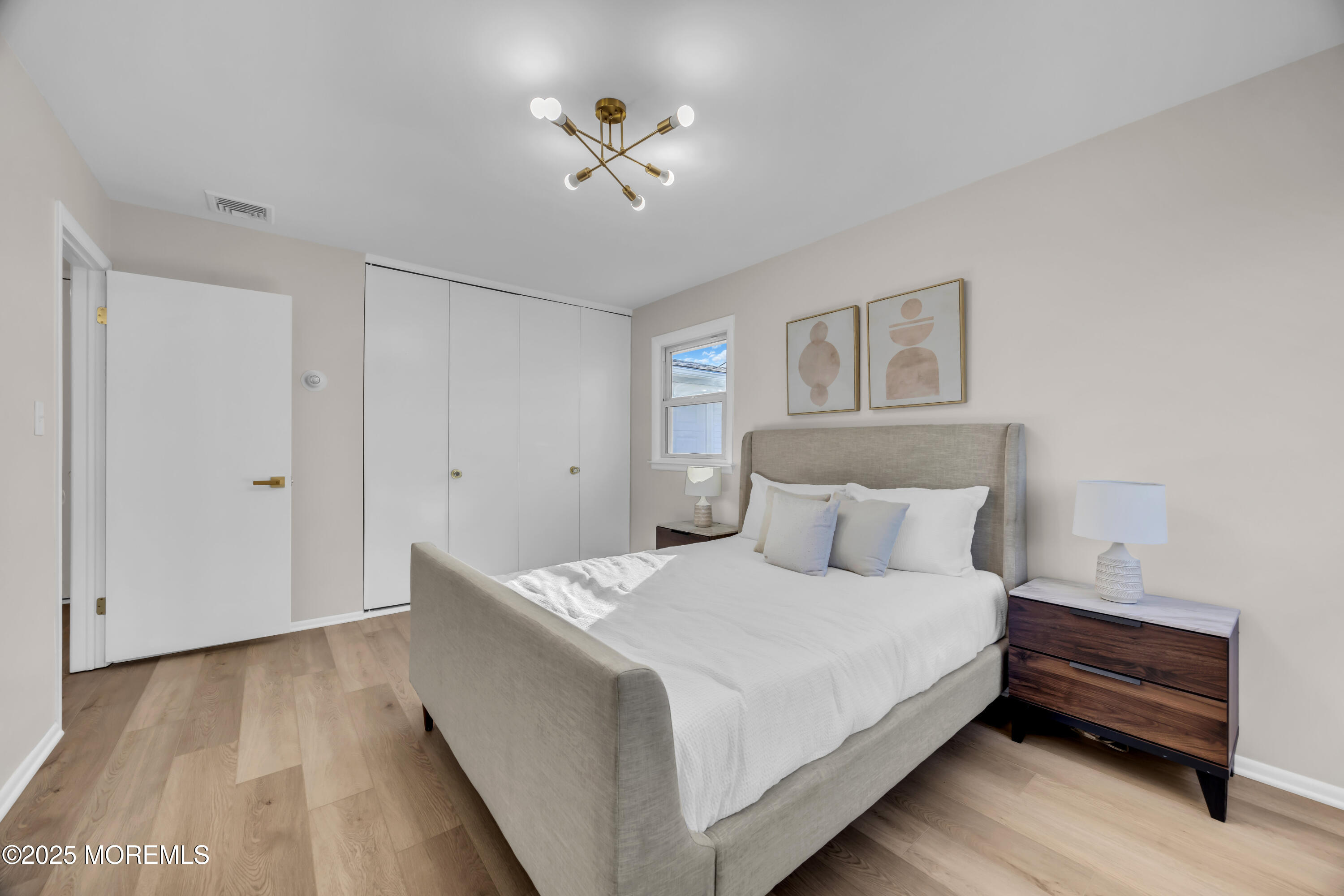 37 Central Boulevard Brick, NJ 08724 - Photo 20 of 32 a bedroom with a bed and a chandelier