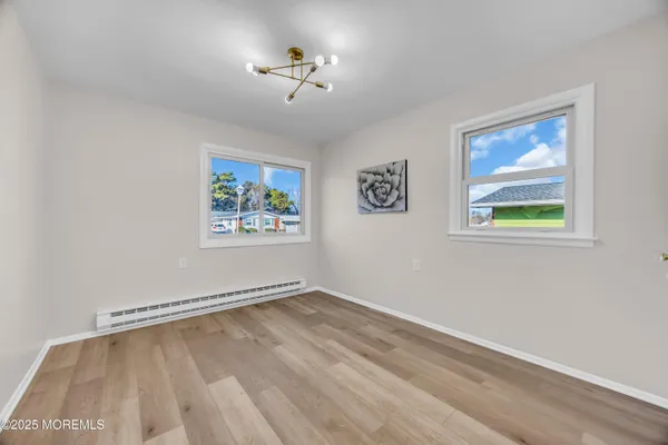 a view of a room with wooden floor