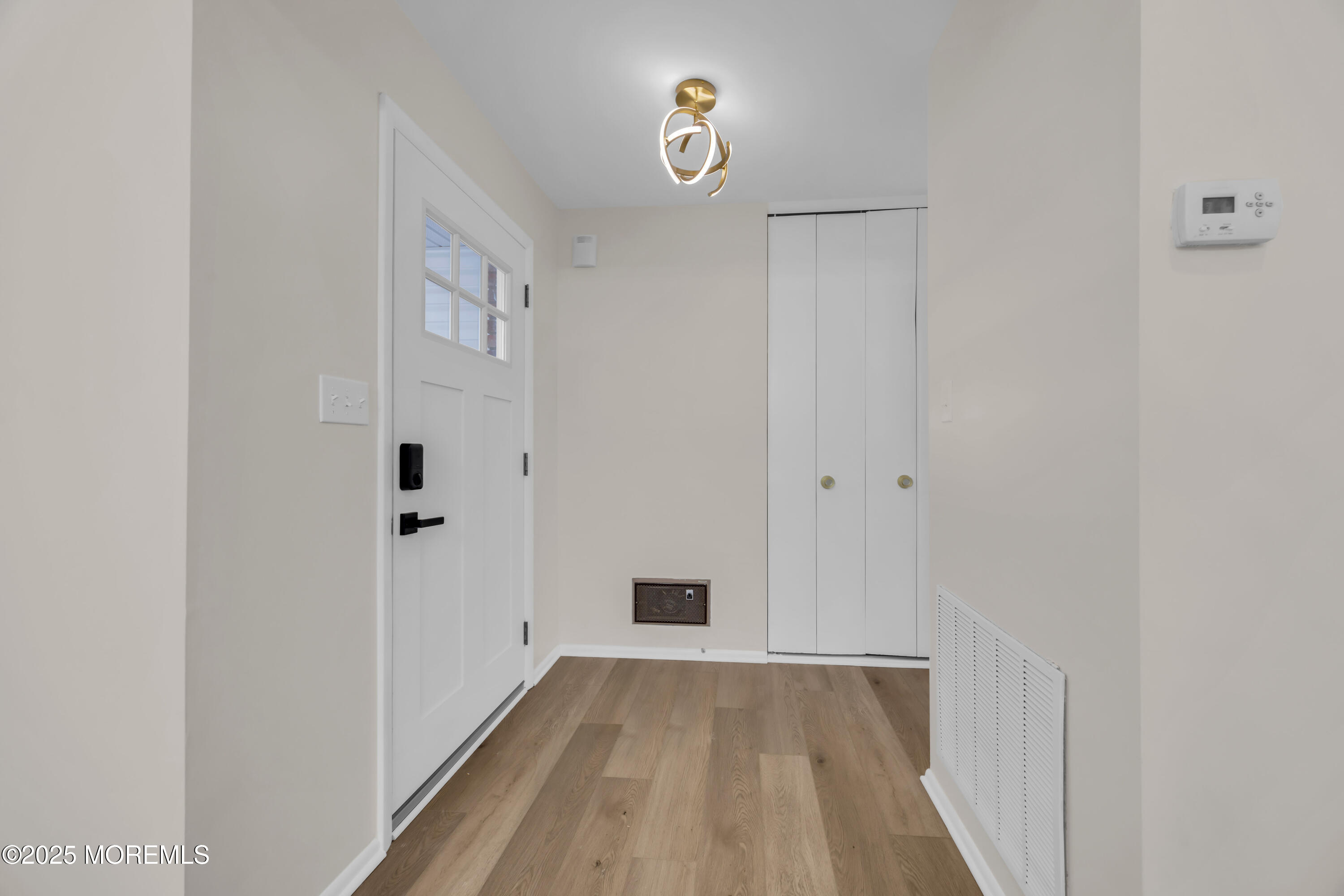 37 Central Boulevard Brick, NJ 08724 - Photo 25 of 32 a view of a hallway with wooden floor and closet