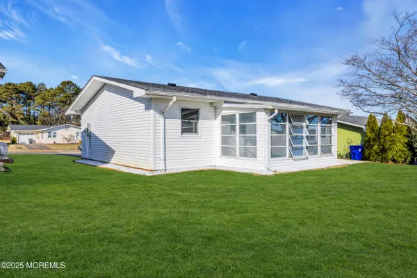 a view of a house with a backyard