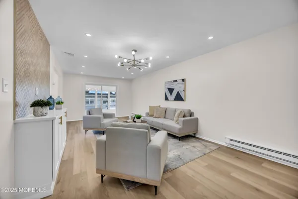 a living room with furniture and a wooden floor